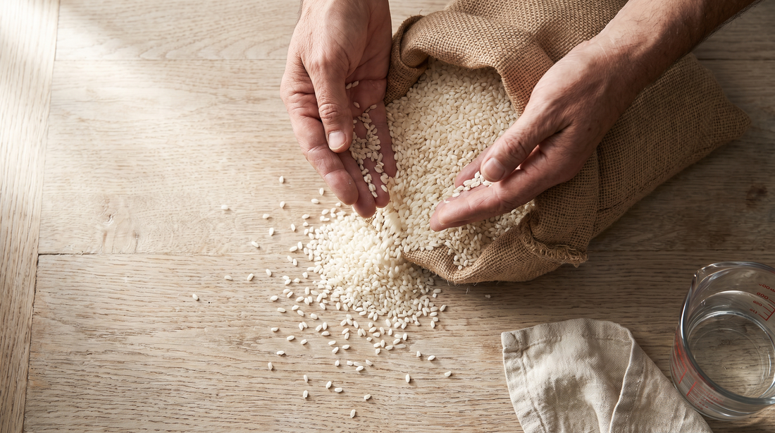 Hands sifting uncooked short-grain rice, the grain usually cooked in nonstick rice cooker pots