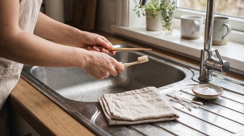 Hands holding a bamboo chopstick and soft toothbrush, tools to clean around rivets without scratching
